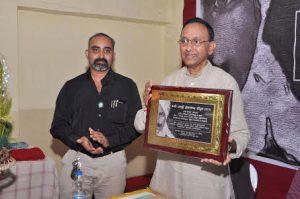 Kumar felicitated with a plaque on Tamil poem book release